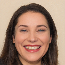 Joyful white young-adult female with long  brown hair and brown eyes