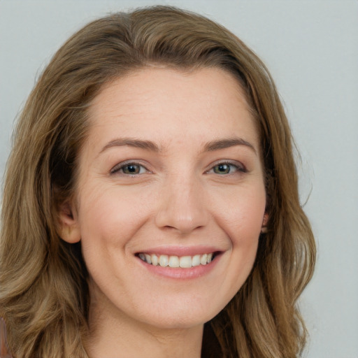 Joyful white young-adult female with long  brown hair and grey eyes