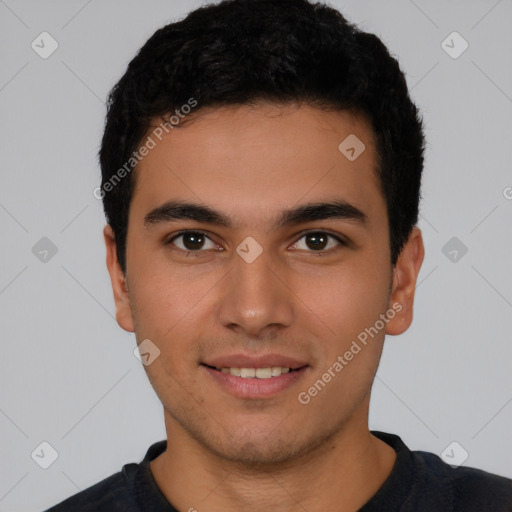 Joyful latino young-adult male with short  black hair and brown eyes