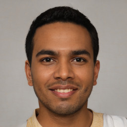 Joyful latino young-adult male with short  black hair and brown eyes