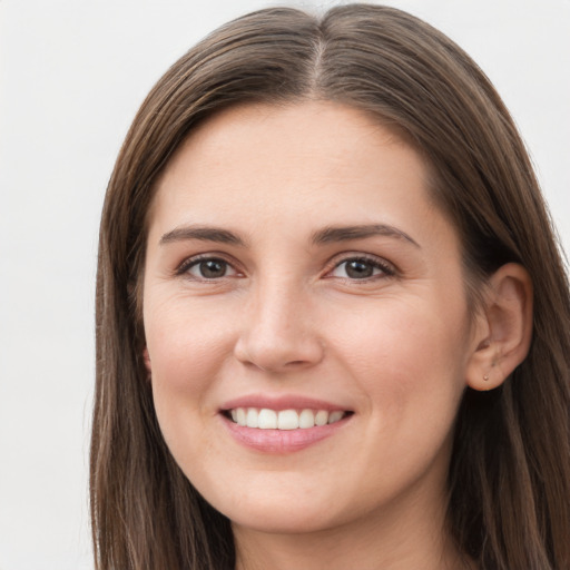 Joyful white young-adult female with long  brown hair and grey eyes