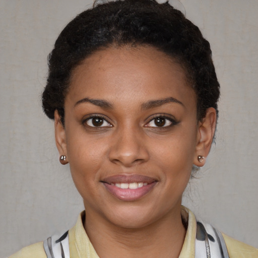 Joyful latino young-adult female with short  black hair and brown eyes