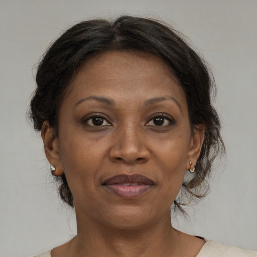 Joyful black adult female with medium  brown hair and brown eyes