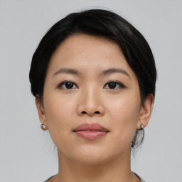 Joyful asian young-adult female with short  black hair and brown eyes