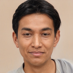 Joyful asian adult male with short  black hair and brown eyes