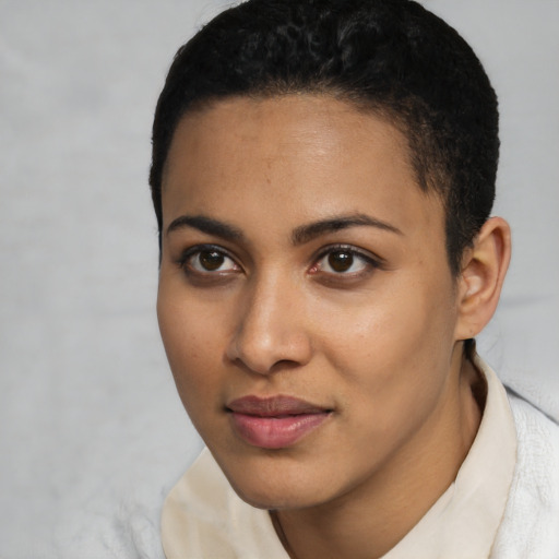 Joyful latino young-adult female with short  black hair and brown eyes