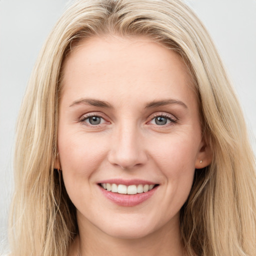 Joyful white young-adult female with long  brown hair and blue eyes