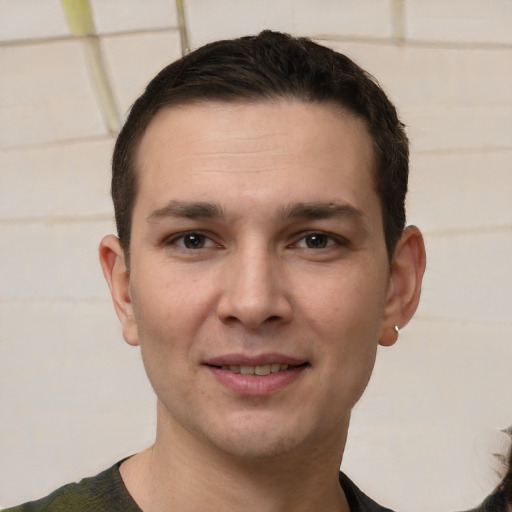 Joyful white young-adult male with short  brown hair and brown eyes