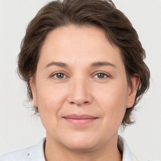 Joyful white adult female with medium  brown hair and brown eyes