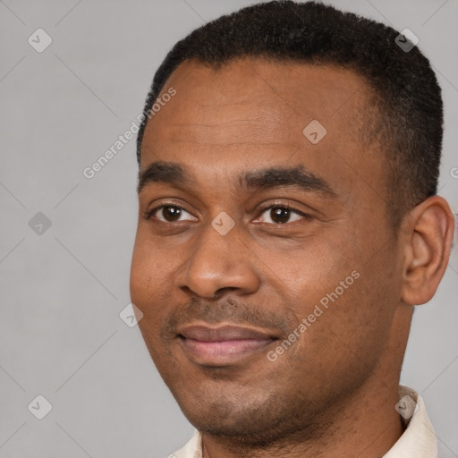 Joyful black young-adult male with short  brown hair and brown eyes