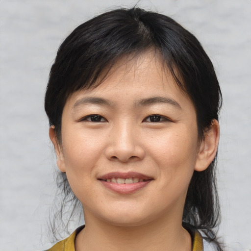 Joyful asian young-adult female with medium  brown hair and brown eyes