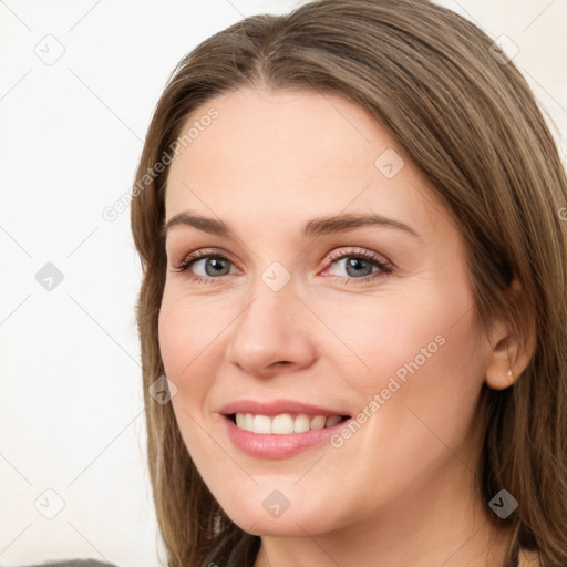 Joyful white young-adult female with long  brown hair and green eyes