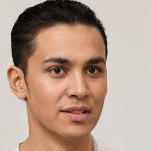 Joyful latino young-adult male with short  brown hair and brown eyes