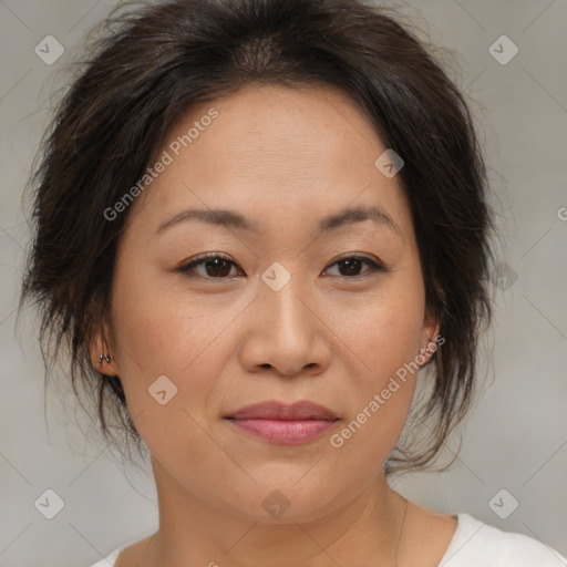 Joyful asian adult female with medium  brown hair and brown eyes