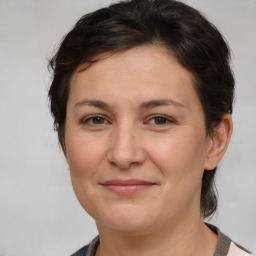 Joyful white adult female with medium  brown hair and brown eyes