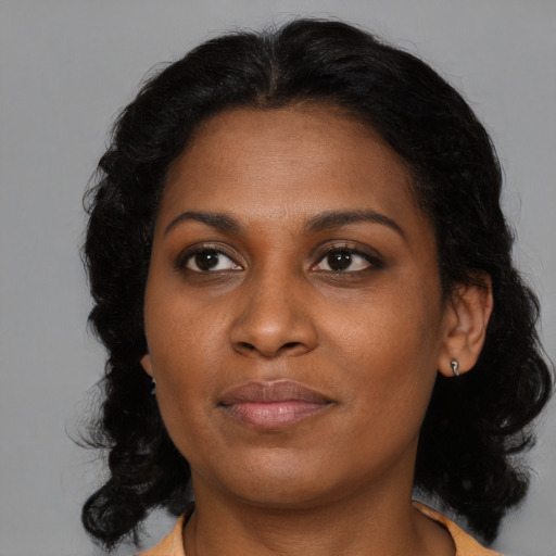 Joyful black young-adult female with medium  brown hair and brown eyes