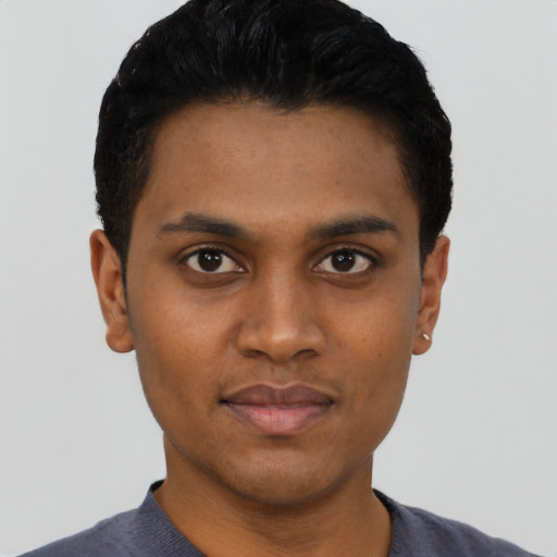 Joyful black young-adult male with short  black hair and brown eyes