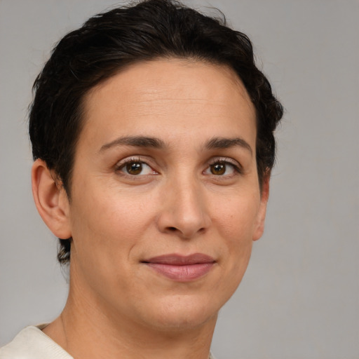 Joyful white adult female with short  brown hair and brown eyes