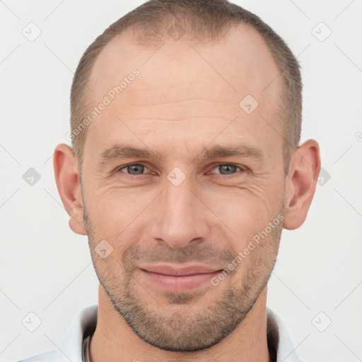 Joyful white adult male with short  brown hair and brown eyes