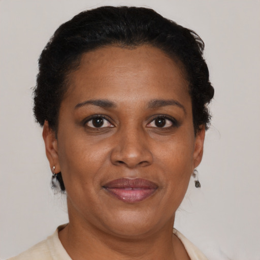 Joyful black adult female with short  brown hair and brown eyes