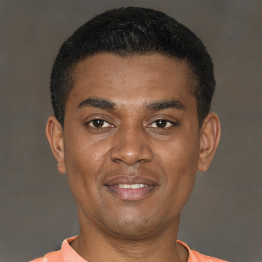 Joyful latino young-adult male with short  brown hair and brown eyes