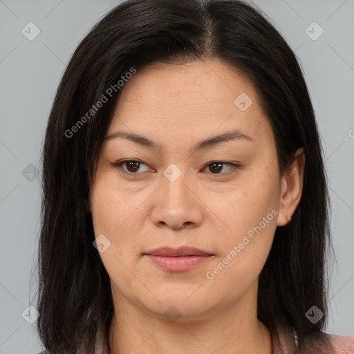 Joyful asian adult female with medium  brown hair and brown eyes