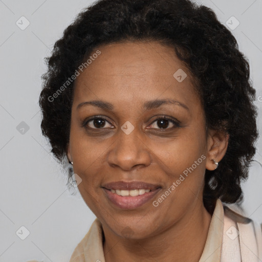 Joyful black adult female with long  brown hair and brown eyes
