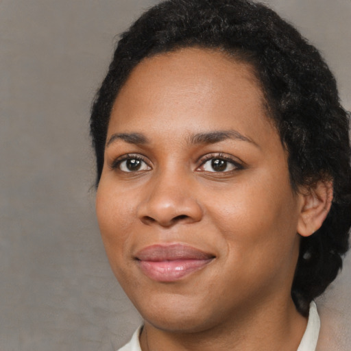 Joyful black young-adult female with medium  brown hair and brown eyes