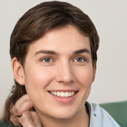 Joyful white young-adult female with short  brown hair and grey eyes