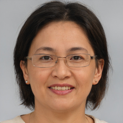 Joyful white adult female with medium  brown hair and brown eyes