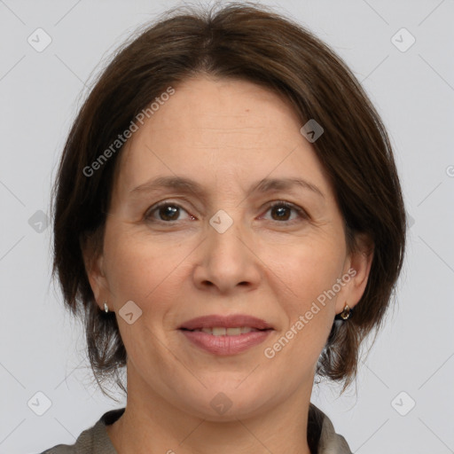 Joyful white adult female with medium  brown hair and brown eyes