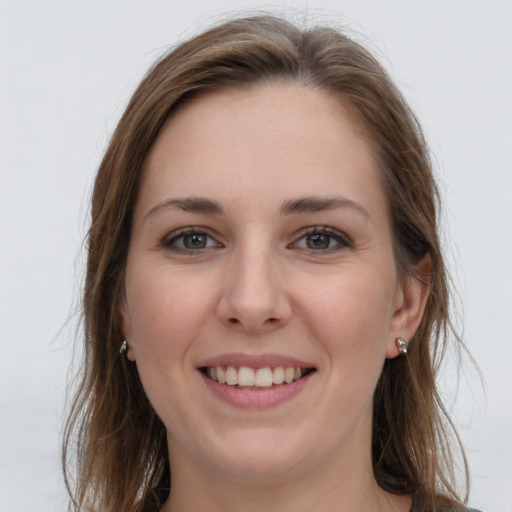 Joyful white young-adult female with long  brown hair and grey eyes