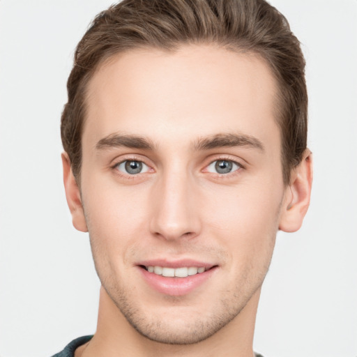 Joyful white young-adult male with short  brown hair and grey eyes