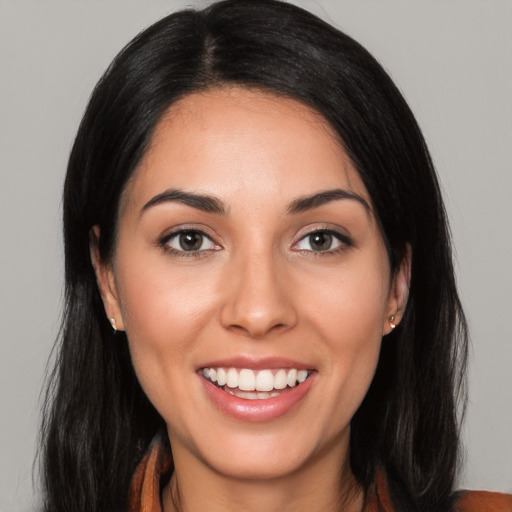 Joyful latino young-adult female with long  black hair and brown eyes