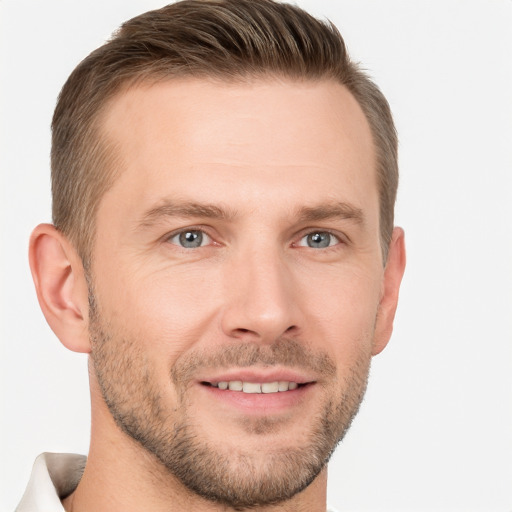 Joyful white young-adult male with short  brown hair and grey eyes