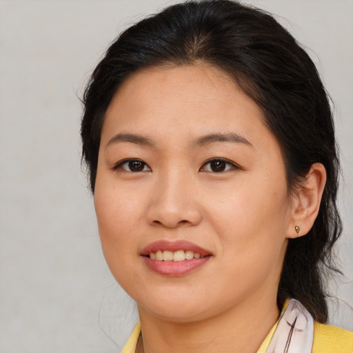 Joyful asian young-adult female with medium  brown hair and brown eyes