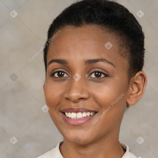 Joyful black young-adult female with short  brown hair and brown eyes