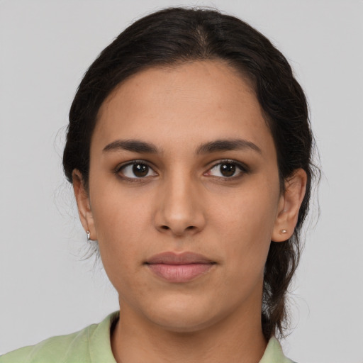 Joyful latino young-adult female with medium  brown hair and brown eyes