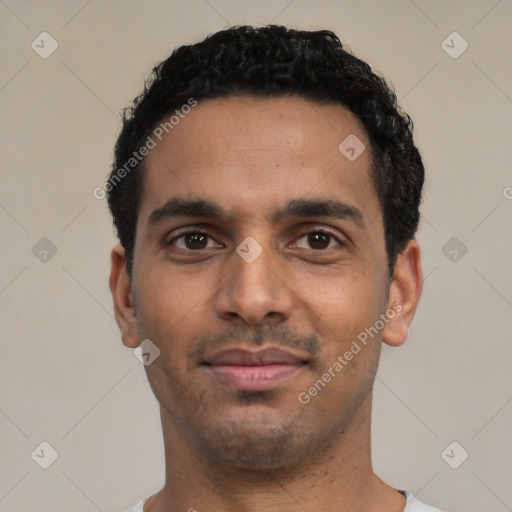 Joyful latino young-adult male with short  black hair and brown eyes