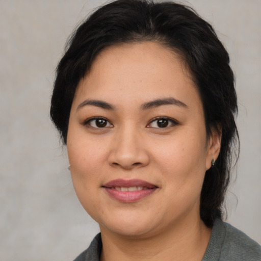 Joyful asian young-adult female with medium  black hair and brown eyes