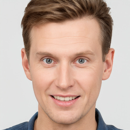 Joyful white adult male with short  brown hair and grey eyes