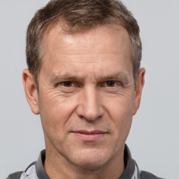 Joyful white middle-aged male with short  brown hair and brown eyes