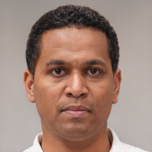 Neutral latino adult male with short  brown hair and brown eyes