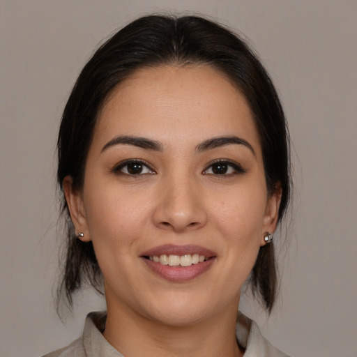 Joyful white young-adult female with medium  brown hair and brown eyes