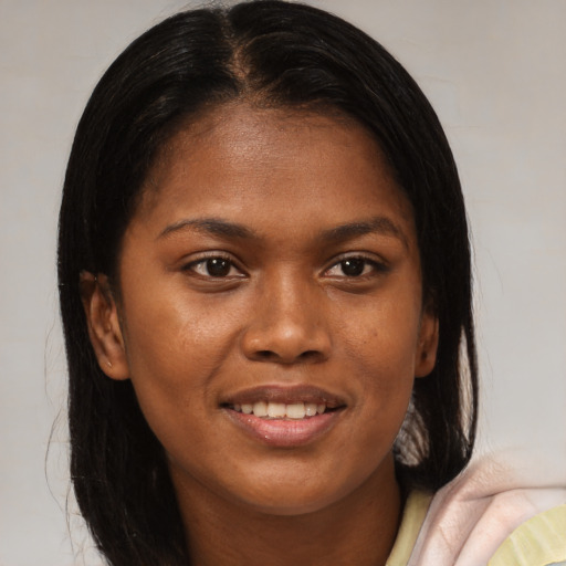 Joyful black young-adult female with medium  brown hair and brown eyes