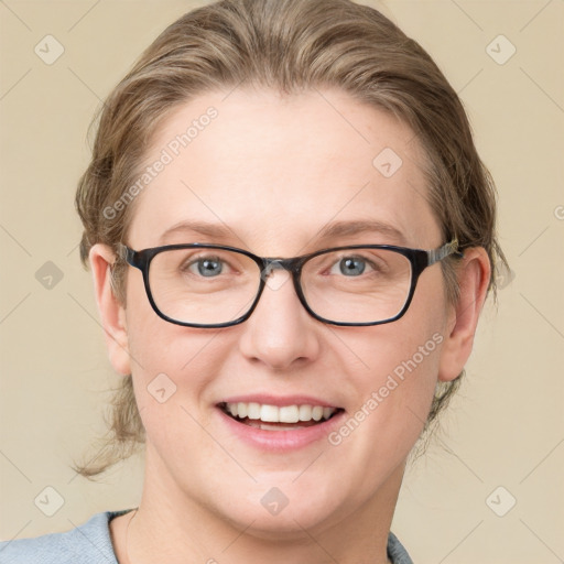 Joyful white adult female with medium  brown hair and blue eyes