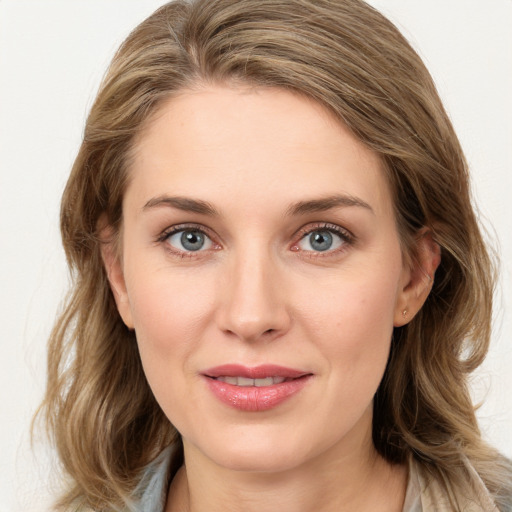 Joyful white young-adult female with long  brown hair and blue eyes