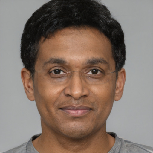 Joyful latino adult male with short  black hair and brown eyes