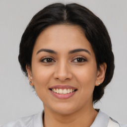 Joyful latino young-adult female with medium  brown hair and brown eyes