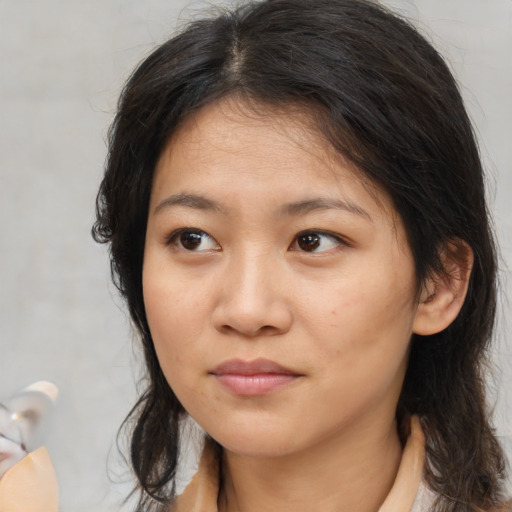 Neutral asian young-adult female with medium  brown hair and brown eyes